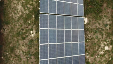 Aerial-view-flying-over-photovoltaic-modules-in-a-solar-park-cloudy-day.-France